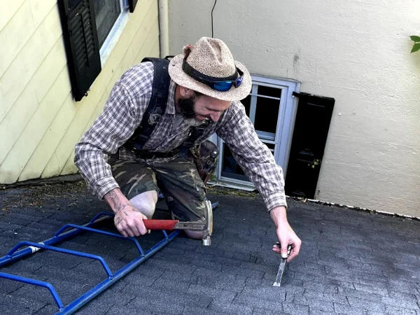 an employee repairing a roof